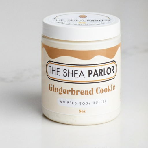 Two jars of 'Gingerbread Cacao' from 'The Shea Parlor' on a light gray background.